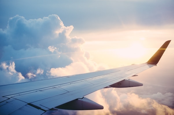 View from airplane window above the clouds